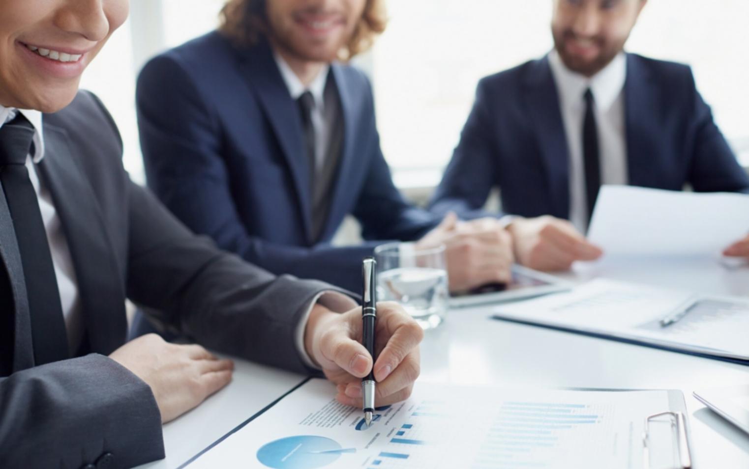 Business professional reviewing strategic documents in modern Cardiff office environment